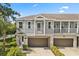 Two-story townhome with a private balcony and a two-car attached garage with a beautifully landscaped front yard at 995 Grand Wildmere, Longwood, FL 32750