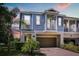 Charming two-story home with a blue exterior, balcony, and attached garage at 995 Grand Wildmere, Longwood, FL 32750