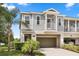 Charming two-story home with a gray exterior, balcony, and attached garage at 995 Grand Wildmere, Longwood, FL 32750