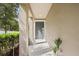Welcoming covered entryway with gray front door and neutral stucco exterior at 995 Grand Wildmere, Longwood, FL 32750