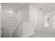 Upstairs hallway with decorative wall, carpeted floor, and doors leading to various rooms at 995 Grand Wildmere, Longwood, FL 32750