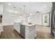 Bright open kitchen with a large island, stainless steel appliances, and a hardwood floor at 995 Grand Wildmere, Longwood, FL 32750