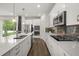 Modern kitchen featuring white cabinets, stainless steel appliances, and island sink at 995 Grand Wildmere, Longwood, FL 32750