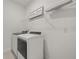Convenient laundry room featuring modern washer and dryer and shelving at 995 Grand Wildmere, Longwood, FL 32750