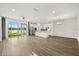 Bright open-plan living area with hardwood floors, modern lighting, and lake view at 995 Grand Wildmere, Longwood, FL 32750