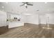 Spacious living room featuring an open floor plan, modern lighting, and beautiful wood-look floors at 995 Grand Wildmere, Longwood, FL 32750
