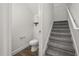 Cozy powder room featuring a toilet and storage under the carpeted staircase landing at 995 Grand Wildmere, Longwood, FL 32750