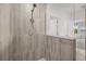 Modern shower featuring light tile, glass partition, and a view of the outdoor landscape at 995 Grand Wildmere, Longwood, FL 32750
