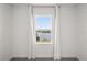 A serene water view framed by a window with elegant white curtains in a bright, minimalist room at 995 Grand Wildmere, Longwood, FL 32750