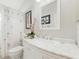 Bright bathroom featuring a marble vanity, decorative mirror, and palm tree shower curtain at 1752 Challenger Ave, Davenport, FL 33897
