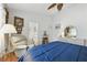 Comfortable bedroom with connecting bathroom, featuring hardwood floors and a ceiling fan at 1752 Challenger Ave, Davenport, FL 33897