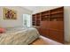 Comfortable bedroom featuring built-in wood shelving, and soft neutral carpeting at 1752 Challenger Ave, Davenport, FL 33897