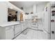 Well-maintained kitchen with white cabinets, modern appliances, and tile floors at 1752 Challenger Ave, Davenport, FL 33897
