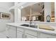 An undermount kitchen sink and dishwasher sit in a kitchen with an open view to the living room at 1752 Challenger Ave, Davenport, FL 33897