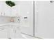 Spacious kitchen boasts white cabinets and countertops, accompanied by a large refrigerator at 1752 Challenger Ave, Davenport, FL 33897