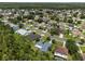 Expansive aerial view of a suburban neighborhood with mature trees and well-maintained homes at 10675 Fairhaven Way, Orlando, FL 32825