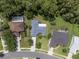 Bird's eye view of the home with a driveway, surrounding trees and other neighborhood houses at 10675 Fairhaven Way, Orlando, FL 32825