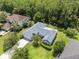 Aerial shot of the home showing the roof, landscaping, driveway and surrounding trees at 10675 Fairhaven Way, Orlando, FL 32825
