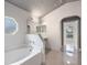 Bathroom featuring a tub, sink with marble countertop, and tiled floors at 10675 Fairhaven Way, Orlando, FL 32825