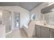 Bright bathroom features a glass shower, garden tub, vanity, and an octagon window at 10675 Fairhaven Way, Orlando, FL 32825