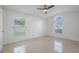 Bright bedroom with two windows, tile floors, and ceiling fan at 10675 Fairhaven Way, Orlando, FL 32825