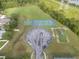Aerial view showcasing community amenities including a tennis court, basketball court, and playground at 10675 Fairhaven Way, Orlando, FL 32825