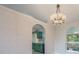 View of the dining room featuring unique wallpaper and archway to the kitchen at 10675 Fairhaven Way, Orlando, FL 32825