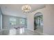 Dining area featuring an elegant chandelier and archway to the kitchen at 10675 Fairhaven Way, Orlando, FL 32825