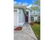 Close-up of the front entrance, showcasing the red door and landscaped walkway at 10675 Fairhaven Way, Orlando, FL 32825