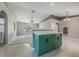 This kitchen features an island with breakfast bar, stylish green cabinets, and sleek white countertops at 10675 Fairhaven Way, Orlando, FL 32825