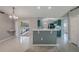 This living room offers a view of the sun room and kitchen with breakfast bar at 10675 Fairhaven Way, Orlando, FL 32825