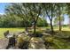 A charming playground surrounded by mature trees and benches invites families to relax and enjoy the natural setting at 10675 Fairhaven Way, Orlando, FL 32825