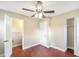 Bright bedroom with wood-look floors, ceiling fan, and closet at 1204 Marie Ave, Apopka, FL 32703