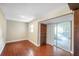 Cozy bedroom with wood-look floors, closet and sliding glass door to the sunroom at 1204 Marie Ave, Apopka, FL 32703