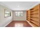Bedroom featuring wood-look floors, natural light, and built-in shelving at 1204 Marie Ave, Apopka, FL 32703