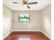 Bright bedroom with a ceiling fan and a large window providing natural light with wood-look floors at 1204 Marie Ave, Apopka, FL 32703