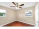 Well-lit bedroom with multiple windows, ceiling fan, and wood-look floors creating a tranquil atmosphere at 1204 Marie Ave, Apopka, FL 32703