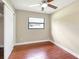 A bright bedroom featuring neutral paint, ceiling fan, and wood-look floors for a relaxing retreat at 1204 Marie Ave, Apopka, FL 32703