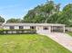 Charming single-story home featuring a lush front yard and covered carport at 1204 Marie Ave, Apopka, FL 32703