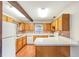 Charming kitchen featuring wood cabinets, tiled backsplash, and a large counter, perfect for cooking and entertaining at 1204 Marie Ave, Apopka, FL 32703