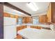 Bright kitchen with wood cabinets, durable countertops and flooring plus a convenient breakfast bar for casual dining at 1204 Marie Ave, Apopka, FL 32703