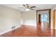 Open-concept living space with wood-look floors and decorative beam accents at 1204 Marie Ave, Apopka, FL 32703