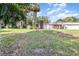 Expansive backyard featuring a large grassy area, mature trees, and a charming gazebo at 123 Se 1St Ave, Webster, FL 33597