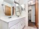 Bright bathroom featuring a double sink vanity and an open closet space with a water heater at 123 Se 1St Ave, Webster, FL 33597