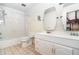 Bright bathroom with double sink vanity and shower-tub combo at 123 Se 1St Ave, Webster, FL 33597