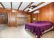 Spacious bedroom features wood paneling, a ceiling fan, and large walk-in closet at 123 Se 1St Ave, Webster, FL 33597