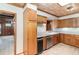 Charming kitchen with wood cabinets, tile floors, and stainless steel dishwasher at 123 Se 1St Ave, Webster, FL 33597