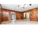 Tile floor living room featuring brick accent and doors to sunroom at 123 Se 1St Ave, Webster, FL 33597