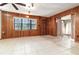 Spacious living room with wood paneling, tile floor, and natural light at 123 Se 1St Ave, Webster, FL 33597