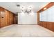 Traditional-style living room featuring wood paneling, tile floors, and a ceiling fan at 123 Se 1St Ave, Webster, FL 33597